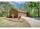 Side view of the brick garage with a two car garage door and landscaping at 1660 Weems Rd, Locust Grove, GA 30248