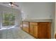 Open kitchen features access to a deck with scenic views and wood cabinets at 1660 Weems Rd, Locust Grove, GA 30248