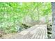 A charming bridge crosses a creek surrounded by mature trees, adding natural beauty to the landscape at 1660 Weems Rd, Locust Grove, GA 30248
