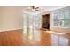 Spacious living room featuring hardwood floors, a wood burning fireplace and large windows at 1660 Weems Rd, Locust Grove, GA 30248