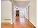 View of the living room with hardwood floors, a wood burning stove and bright natural light at 1660 Weems Rd, Locust Grove, GA 30248