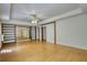Bright living room with wooden floors, custom shelving, and mirrored wall accents at 1660 Weems Rd, Locust Grove, GA 30248