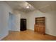 Living room with wood floors, a vintage hutch, and a secure gun safe at 1660 Weems Rd, Locust Grove, GA 30248
