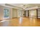 Spacious living room with hardwood floors, natural light, and custom shelving units at 1660 Weems Rd, Locust Grove, GA 30248