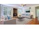 Bright living room with a wood-burning fireplace, hardwood floors, and ample natural light at 1660 Weems Rd, Locust Grove, GA 30248