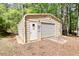 Metal outbuilding with roll up door for storage of property maintenance equipment at 1660 Weems Rd, Locust Grove, GA 30248