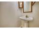 Traditional powder room features a pedestal sink and vintage-style mirror and light fixture at 1660 Weems Rd, Locust Grove, GA 30248