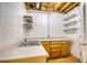Functional utility room with double sink, cabinetry, and open shelving for storage at 1660 Weems Rd, Locust Grove, GA 30248