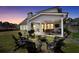 Relaxing backyard with a covered patio featuring a table and chairs, a fire pit, and outdoor seating at 220 Alcovy Reserve Way, Covington, GA 30014