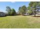 Expansive backyard with a shed, fence, and ample space for outdoor activities, providing privacy and room to roam at 220 Alcovy Reserve Way, Covington, GA 30014