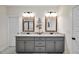 Charming bathroom features a double vanity with granite countertops and framed mirrors at 220 Alcovy Reserve Way, Covington, GA 30014