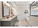 Well-appointed bathroom with double vanity, granite countertops, a soaking tub, and a separate shower at 220 Alcovy Reserve Way, Covington, GA 30014