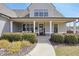 Welcoming front porch with classic columns and lush landscaping, providing an inviting entrance to the home at 220 Alcovy Reserve Way, Covington, GA 30014