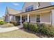 Inviting front porch with classic columns and beautiful landscaping, creating a welcoming entrance to the home at 220 Alcovy Reserve Way, Covington, GA 30014