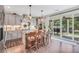 Open kitchen with gray cabinets, granite countertops, and a sliding glass door to the patio at 220 Alcovy Reserve Way, Covington, GA 30014