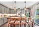 Bright kitchen island with stone accents, pendant lighting, and modern appliances at 220 Alcovy Reserve Way, Covington, GA 30014