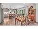 View of the dining area and kitchen with gray cabinets and an island with barstool seating at 220 Alcovy Reserve Way, Covington, GA 30014