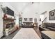 Spacious living room boasts high ceilings, stone fireplace, and comfortable leather furniture at 220 Alcovy Reserve Way, Covington, GA 30014