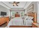 Spacious main bedroom features a tray ceiling, wood furniture, and a decorative wall sign at 220 Alcovy Reserve Way, Covington, GA 30014