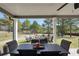 Covered patio featuring a dining table, chairs, and a cozy seating area, ideal for outdoor entertaining at 220 Alcovy Reserve Way, Covington, GA 30014