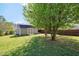 Charming backyard shed nestled beneath a large tree, offering additional storage or workspace at 220 Alcovy Reserve Way, Covington, GA 30014