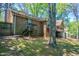 View of backyard with brick home, deck, and wooden fence at 2352 Rockwood Way, Stone Mountain, GA 30087