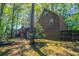 Scenic view of the brick home surrounded by lush trees at 2352 Rockwood Way, Stone Mountain, GA 30087