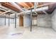 Unfinished basement with concrete floor, exposed ceiling, support beams and brick walls at 2352 Rockwood Way, Stone Mountain, GA 30087