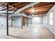 Unfinished basement featuring concrete floors, support beams, and exposed ceiling with pipes at 2352 Rockwood Way, Stone Mountain, GA 30087
