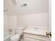 Cozy bathroom featuring a vanity sink, a toilet, and a bathtub with white tiles at 2352 Rockwood Way, Stone Mountain, GA 30087