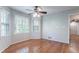 Bright bedroom featuring hardwood floors, large windows, and a ceiling fan for added comfort and natural light at 2352 Rockwood Way, Stone Mountain, GA 30087
