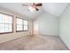 Bright bedroom with plush carpeting, vaulted ceiling, large windows, and a ceiling fan at 2352 Rockwood Way, Stone Mountain, GA 30087