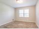 Clean bedroom featuring neutral colors, plush carpeting, and a window at 2352 Rockwood Way, Stone Mountain, GA 30087