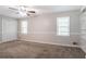 Spacious bedroom with two windows, ceiling fan, and built in shelving at 2352 Rockwood Way, Stone Mountain, GA 30087