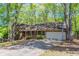 One story brick home featuring a two car garage and mature trees at 2352 Rockwood Way, Stone Mountain, GA 30087