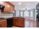 Warm kitchen with wood cabinets, black appliances, tile backsplash and hardwood floors at 2352 Rockwood Way, Stone Mountain, GA 30087