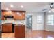 Modern kitchen with wood cabinets, granite countertops, stainless steel appliances, and hardwood floors at 2352 Rockwood Way, Stone Mountain, GA 30087