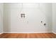 Clean laundry area with hardwood flooring and hookups, providing convenience at 2352 Rockwood Way, Stone Mountain, GA 30087