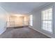 Spacious living room with plush carpeting, neutral paint, and plenty of natural light at 2352 Rockwood Way, Stone Mountain, GA 30087