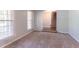 Living room with plush carpeting, neutral paint, with staircase access at 2352 Rockwood Way, Stone Mountain, GA 30087