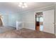 Living room features plush carpet, neutral paint, and access to a kitchen at 2352 Rockwood Way, Stone Mountain, GA 30087