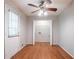 Room with wood floors, ceiling fan and a door leading to a storage area at 2352 Rockwood Way, Stone Mountain, GA 30087