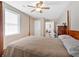 Bright bedroom with wood-look floors, a ceiling fan, and an open doorway at 40 L Z Jackson Road, Bowdon, GA 30108