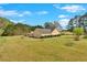 Single-story home with a well-maintained lawn, manicured shrubs, and a charming patio area with fire pit at 40 L Z Jackson Road, Bowdon, GA 30108