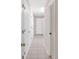 The long hallway has multiple doors and tile flooring at 40 L Z Jackson Road, Bowdon, GA 30108