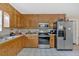 This kitchen features stainless steel appliances, plenty of counter space, and bright wood cabinets at 40 L Z Jackson Road, Bowdon, GA 30108