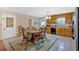 Open kitchen with a dining area, stainless steel refrigerator, tile floor, and natural lighting at 40 L Z Jackson Road, Bowdon, GA 30108