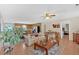 Spacious living room with kitchen view features a ceiling fan, hard wood floors, and modern decor at 40 L Z Jackson Road, Bowdon, GA 30108