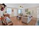Bright living room with a ceiling fan, wooden floors, and natural light from the windows at 40 L Z Jackson Road, Bowdon, GA 30108