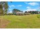 Large grassy yard with the rear of the home, patio, and perimeter trees at 40 L Z Jackson Road, Bowdon, GA 30108